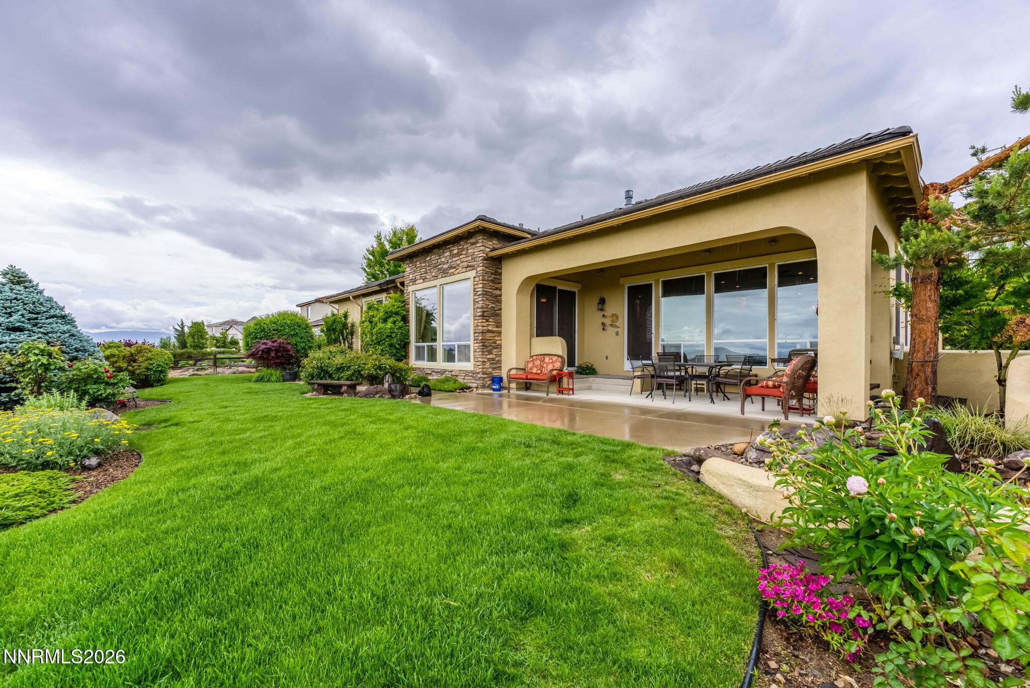 10170 Vía Como Reno, NV 89511 - Photo 44 of 85 a view of a white house with a big yard and potted plants
