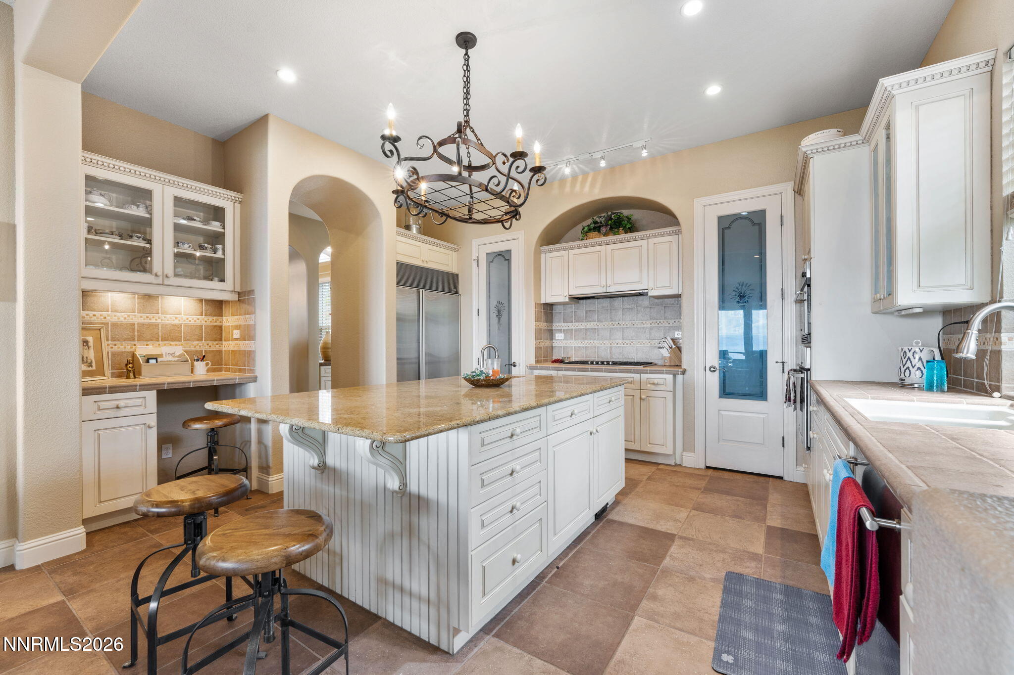 10170 Vía Como Reno, NV 89511 - Photo 6 of 85 a large kitchen with kitchen island a large counter top space a sink stainless steel appliances and cabinets