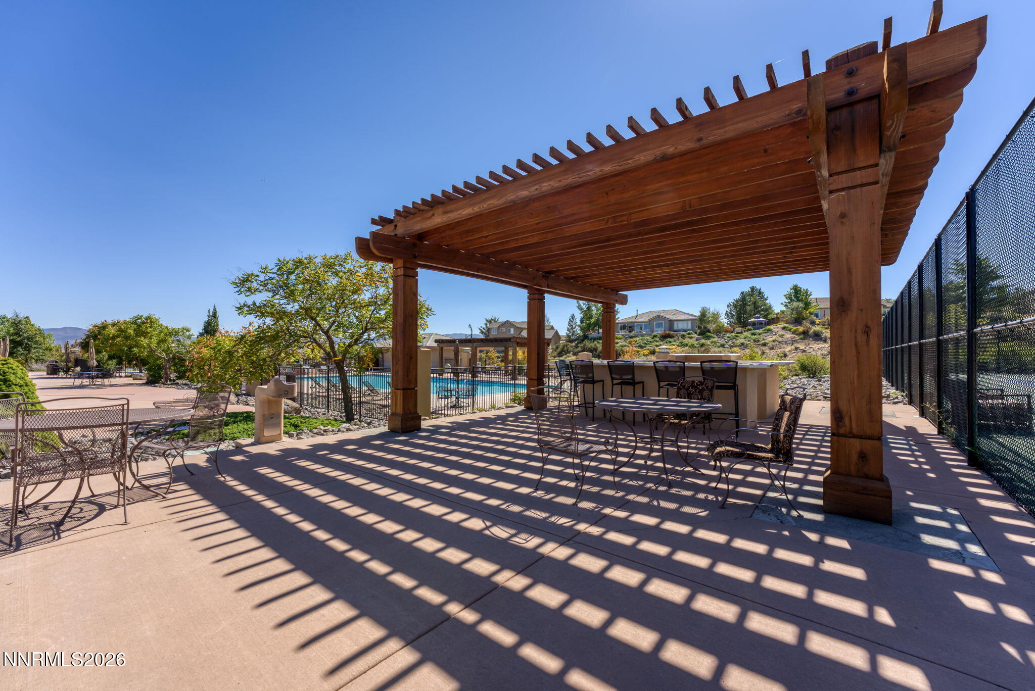 10170 Vía Como Reno, NV 89511 - Photo 71 of 85 a view of a patio with table and chairs with wooden floor and fence