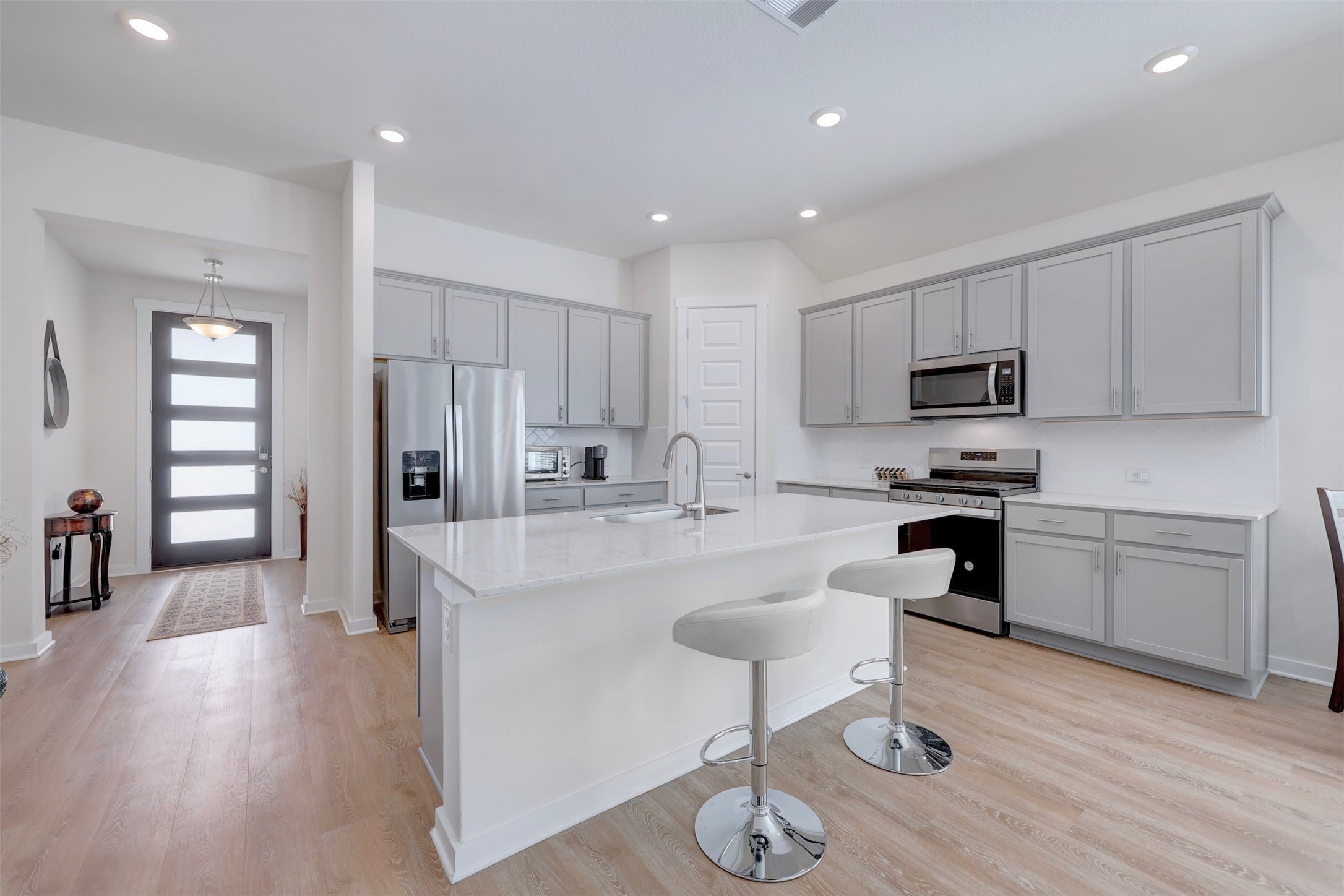 2041 Centerline Lane Georgetown, TX 78628 - Photo 6 of 31 a kitchen with white cabinets and stainless steel appliances