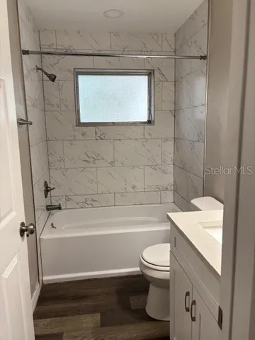 a bathroom with a toilet a sink and bathtub