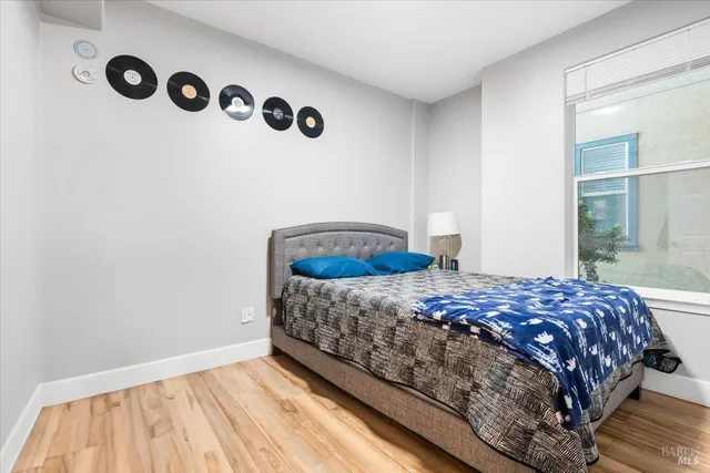 a bedroom with a bed and window