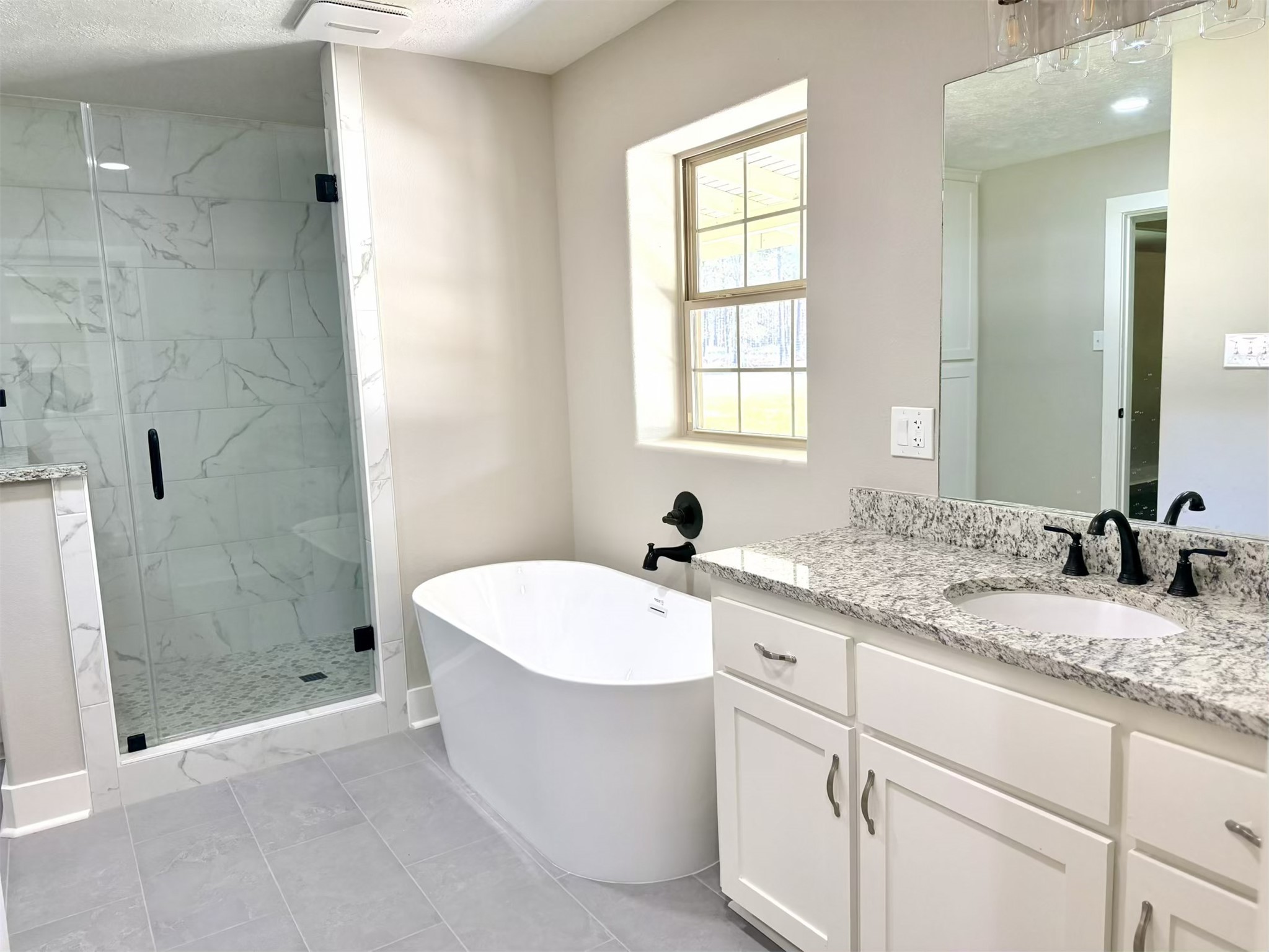 335 Walding Road Livingston, TX 77351 - Photo 11 of 23 a bathroom with a granite countertop sink a toilet a mirror and shower