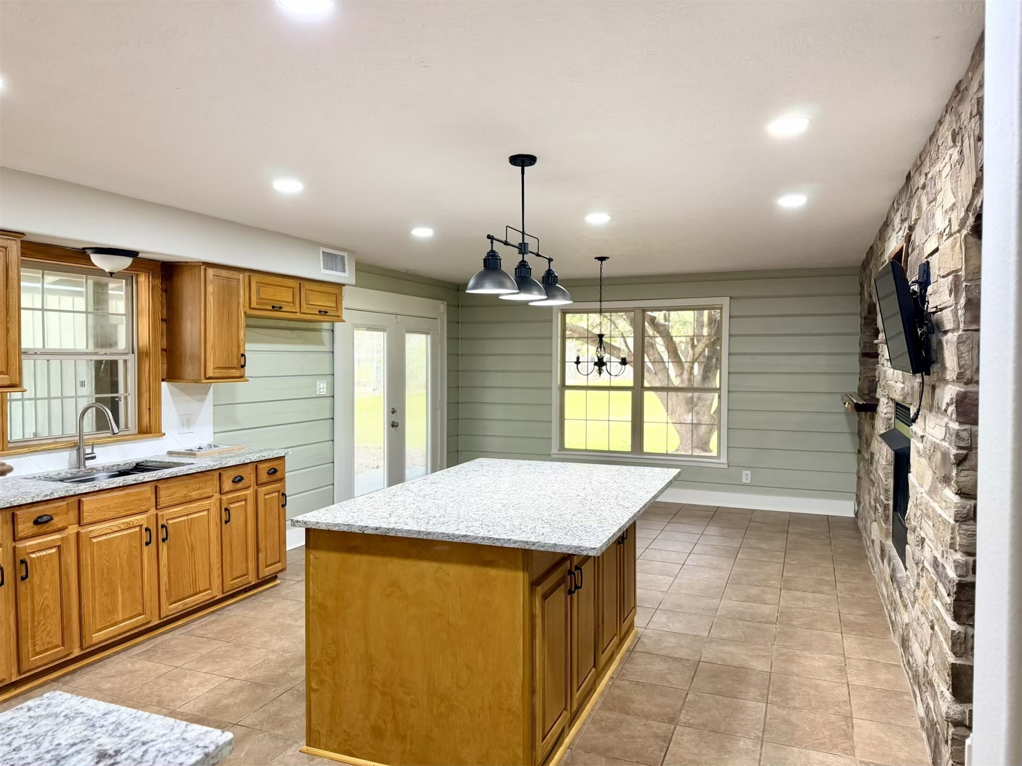 335 Walding Road Livingston, TX 77351 - Photo 5 of 23 a large kitchen with kitchen island a sink stainless steel appliances and cabinets