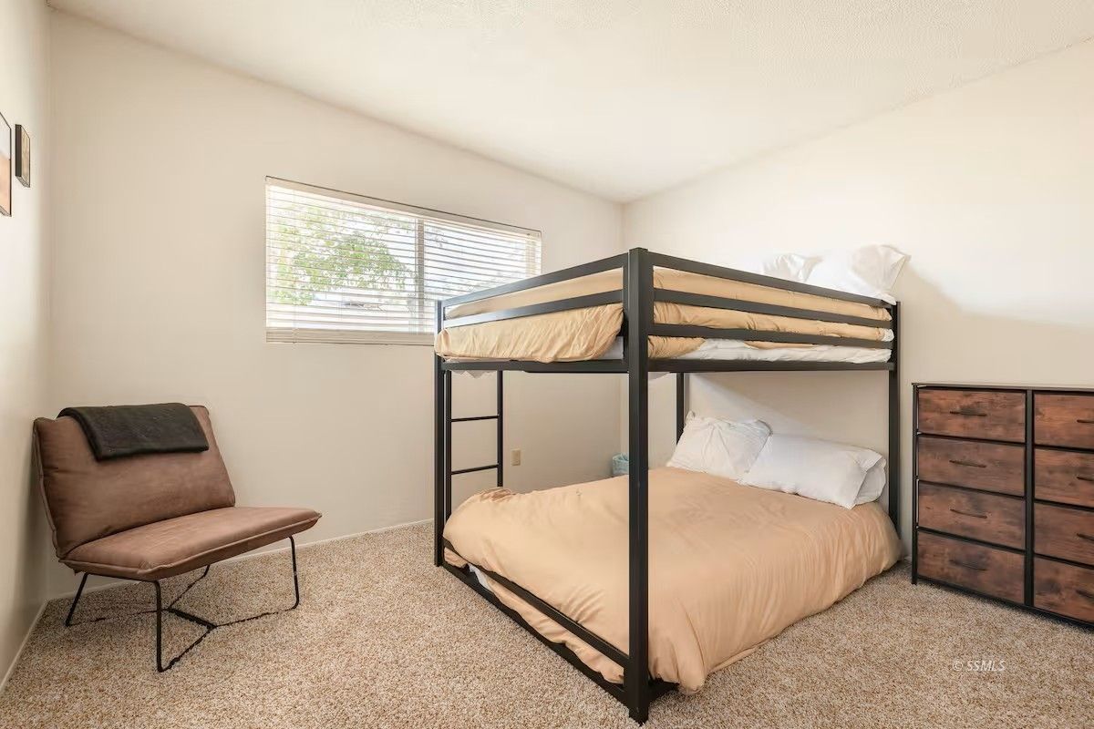 217 South Silver Ridge Street Ridgecrest, CA 93555 - Photo 11 of 20 a bedroom with a bed and a chair