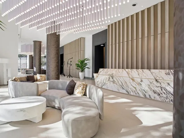 a living room with furniture and a mirror