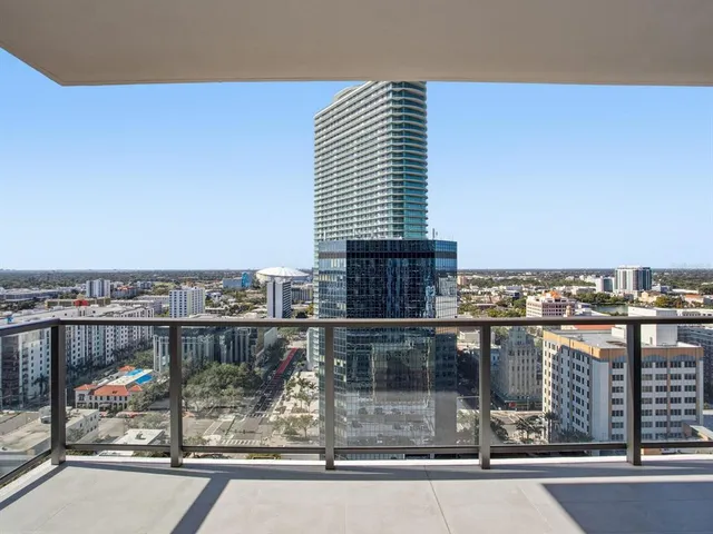 a kitchen with stainless steel appliances granite countertop a sink and a white cabinets