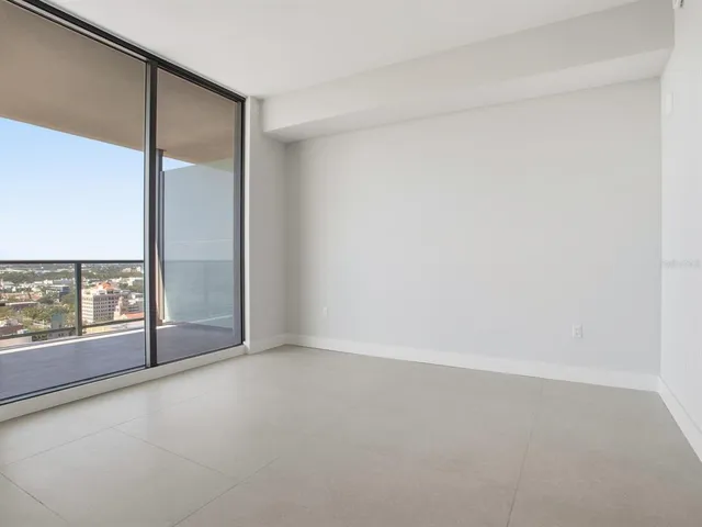 a living room with furniture a rug and a window
