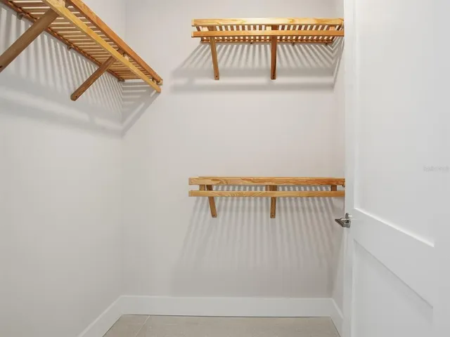 a view of a room with gym equipment and floor to ceiling window