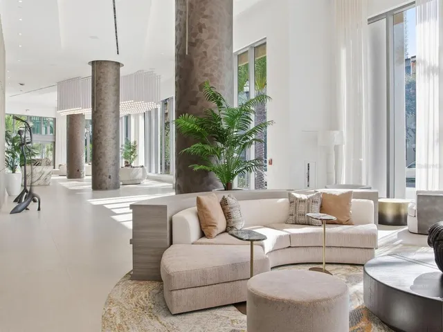 a living room with furniture and a painting on the wall