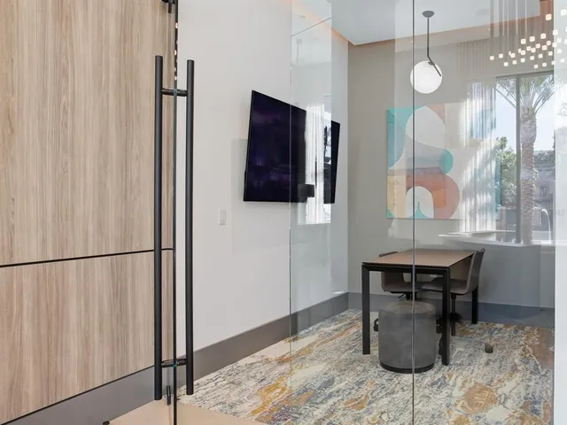 a kitchen with white cabinets and sink