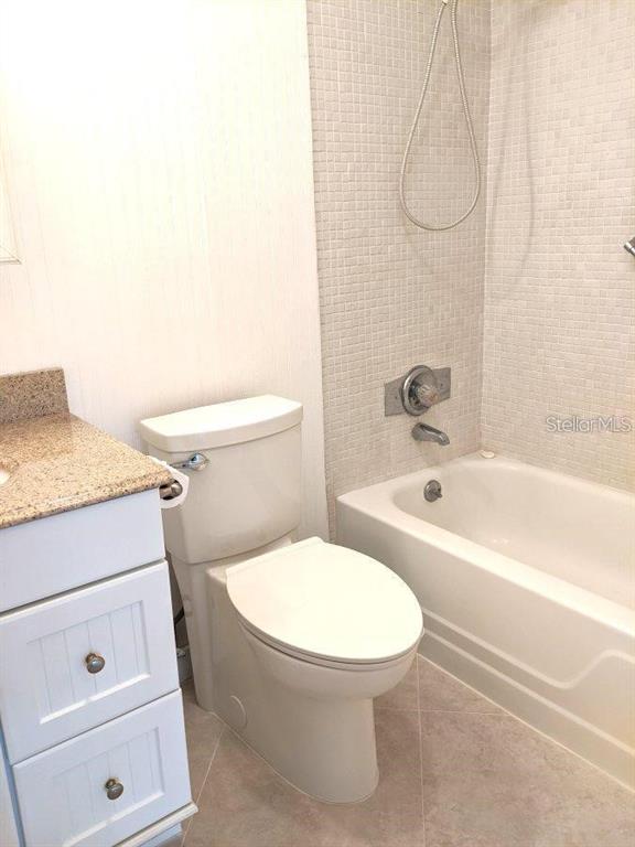 201 Bedford Trail, Unit F127 Sun City Center, FL 33573 - Photo 14 of 15 a bathroom with a sink a toilet and bathtub