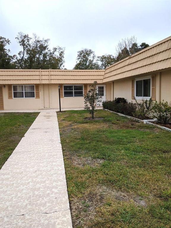 201 Bedford Trail, Unit F127 Sun City Center, FL 33573 - Photo 2 of 15 a front view of house with yard barbeque and outdoor seating