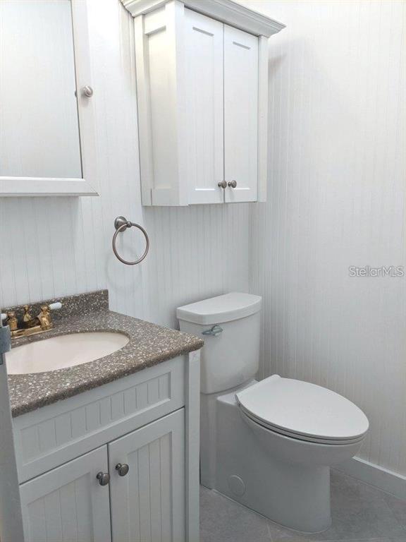 201 Bedford Trail, Unit F127 Sun City Center, FL 33573 - Photo 9 of 15 a bathroom with a granite countertop toilet and sink