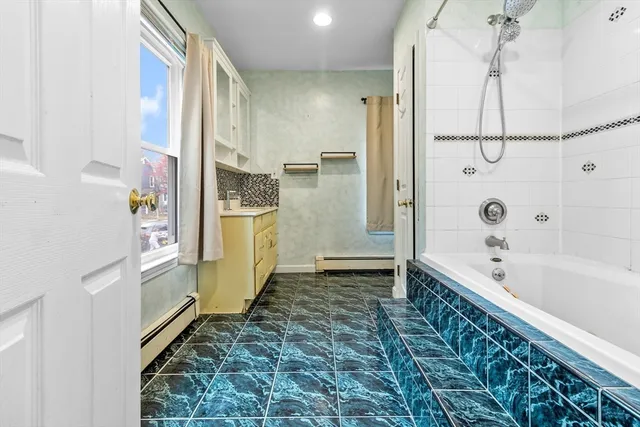 a bathroom with a bathtub and a shower