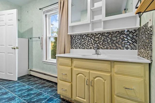 a bathroom with a bathtub and shower