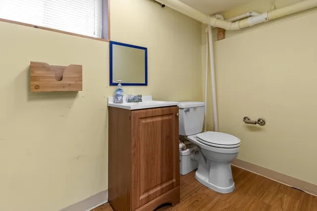 a bathroom with a toilet a sink and mirror