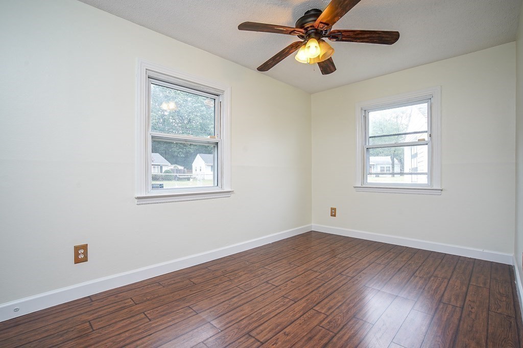 81 Pembroke Circle Springfield, MA 01104 - Photo 11 of 14 a view of empty room with wooden floor and fan