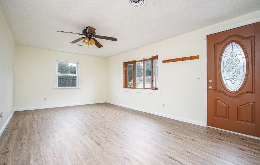 81 Pembroke Circle Springfield, MA 01104 - Photo 2 of 14 an empty room with wooden floor chandelier fan and windows
