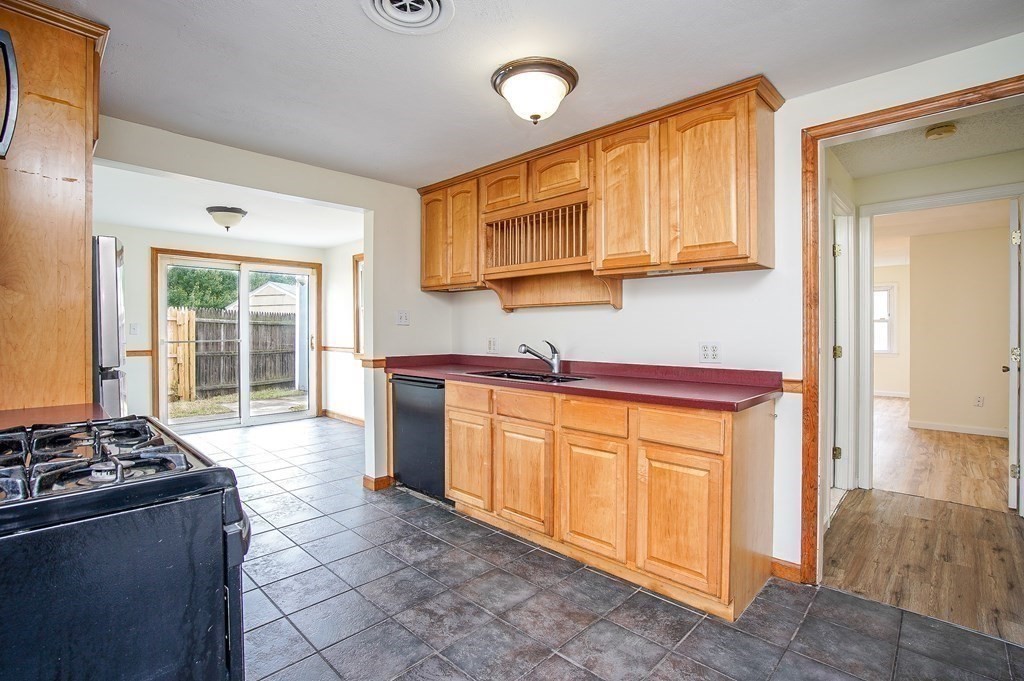 81 Pembroke Circle Springfield, MA 01104 - Photo 5 of 14 a kitchen with stainless steel appliances granite countertop a stove a sink and a refrigerator