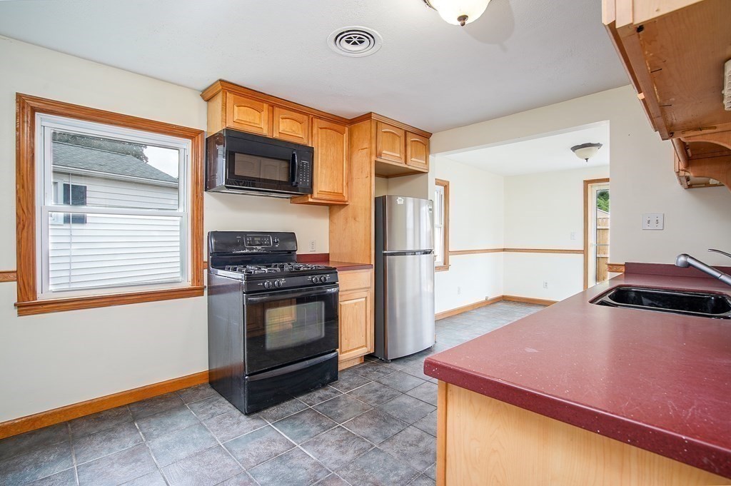 81 Pembroke Circle Springfield, MA 01104 - Photo 6 of 14 a kitchen with stainless steel appliances a sink a stove a refrigerator and cabinets