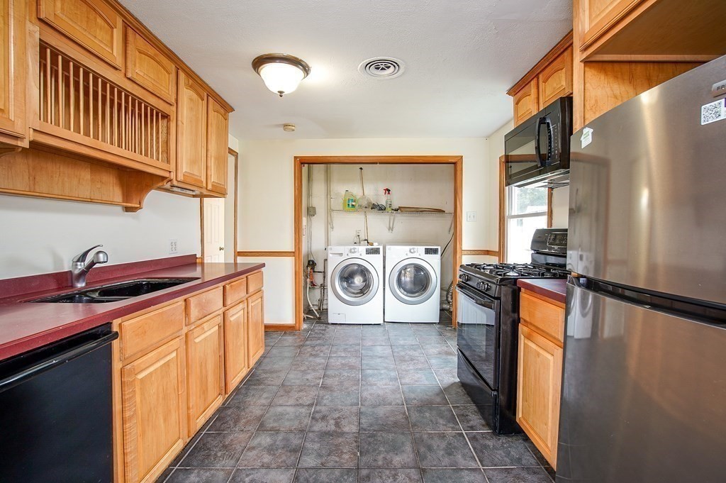 81 Pembroke Circle Springfield, MA 01104 - Photo 7 of 14 a kitchen with stainless steel appliances granite countertop a sink a stove and a refrigerator