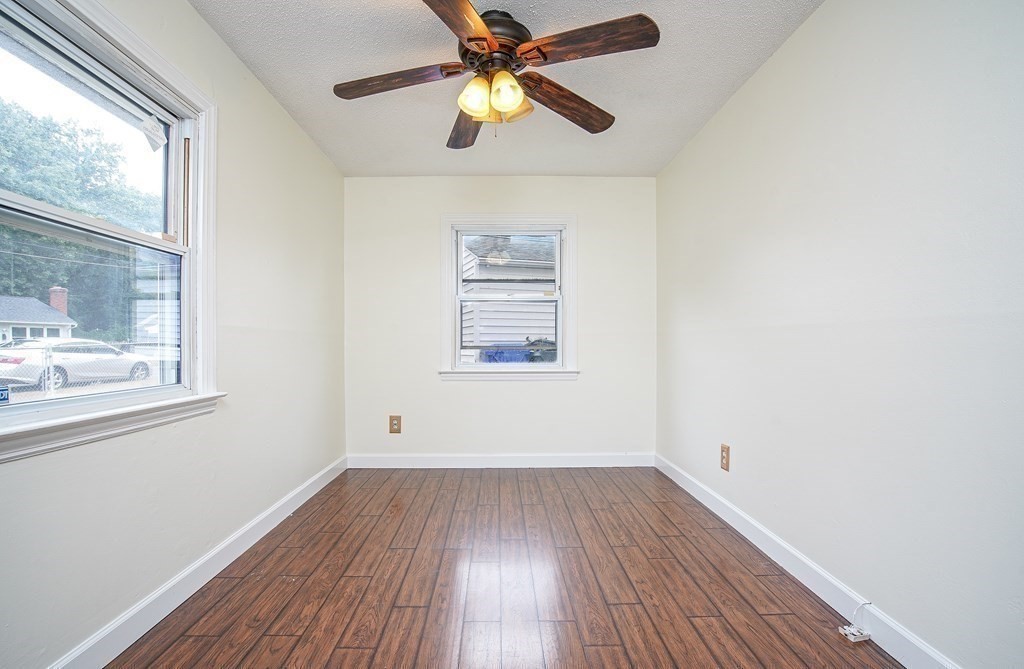 81 Pembroke Circle Springfield, MA 01104 - Photo 10 of 14 a view of empty room with wooden floor and fan