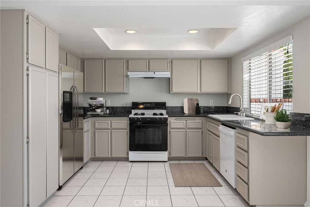 711 Santa Rosa San Dimas, CA 91773 - Photo 11 of 32 a kitchen with a sink a stove and cabinets