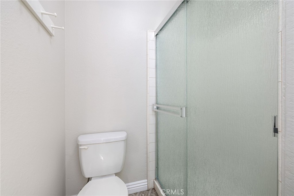 711 Santa Rosa San Dimas, CA 91773 - Photo 21 of 32 a white toilet sitting next to a shower