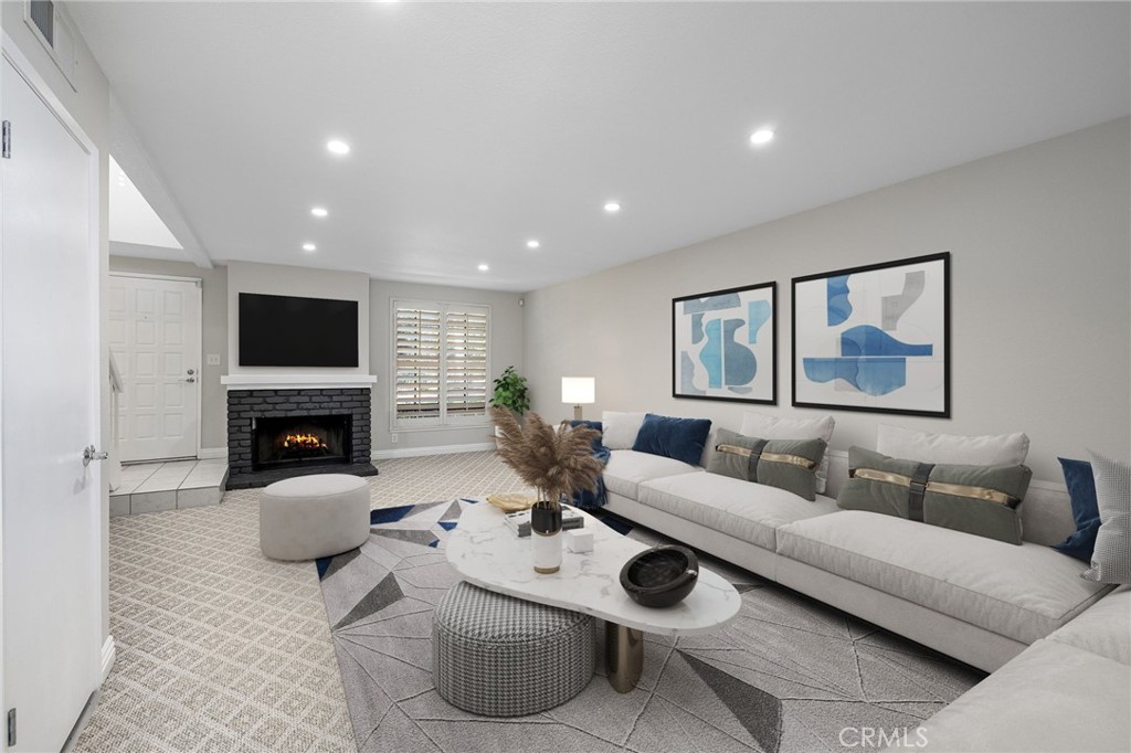 711 Santa Rosa San Dimas, CA 91773 - Photo 4 of 32 a living room with furniture a fireplace and a flat screen tv