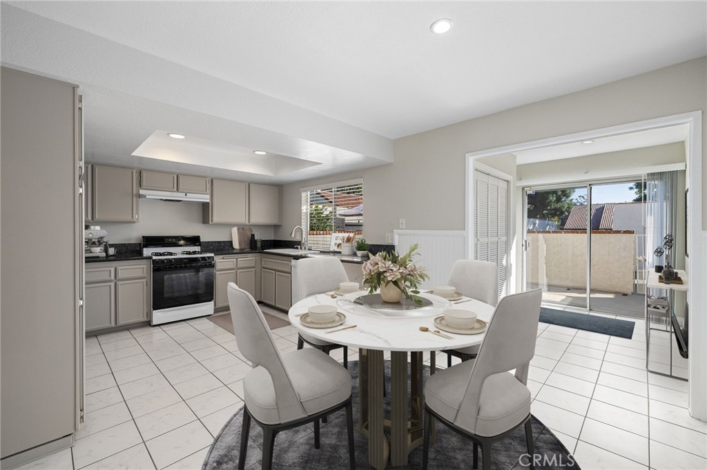 711 Santa Rosa San Dimas, CA 91773 - Photo 9 of 32 a kitchen with a dining table chairs and white appliances