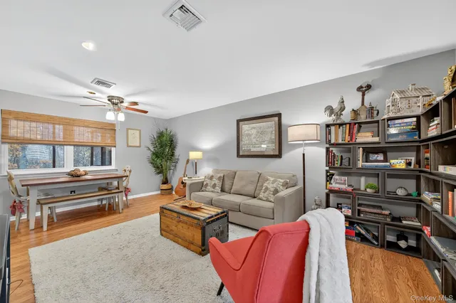 a living room with furniture a air conditioner and a window