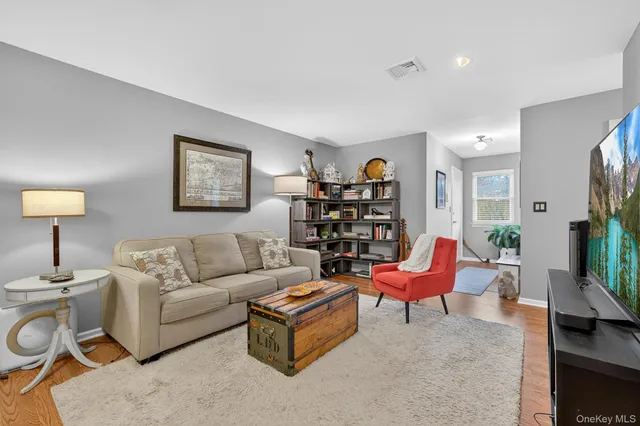 a living room with furniture a lamp and a potted plant