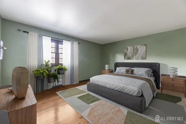 a bedroom with a bed and a painting on the wall