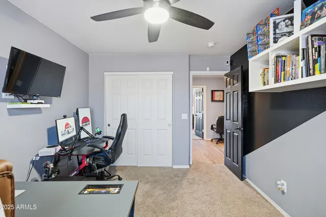 a view of a workspace with furniture and a flat screen tv