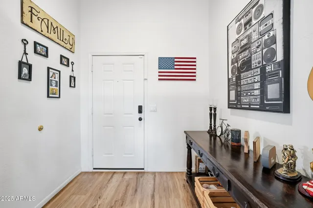 a view of a hallway with workspace and wooden floor