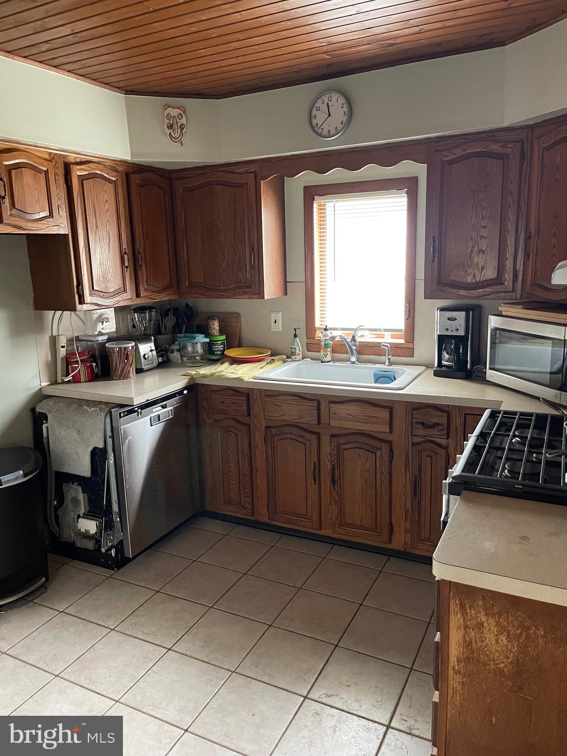 121 Spring Garden Street Riverside, NJ 08075 - Photo 13 of 26 a kitchen with a sink a stove a microwave and cabinets