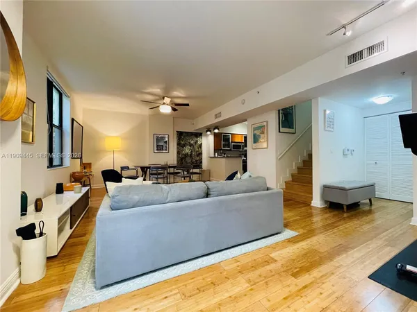 a living room with furniture and a flat screen tv