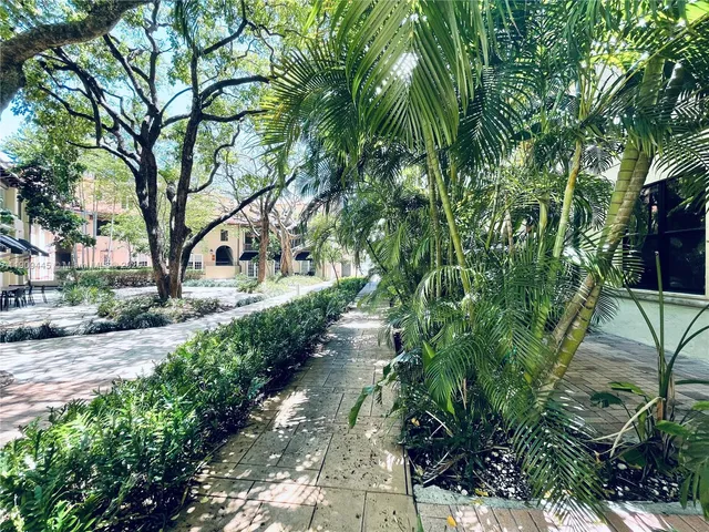 a view of a pathway with a yard