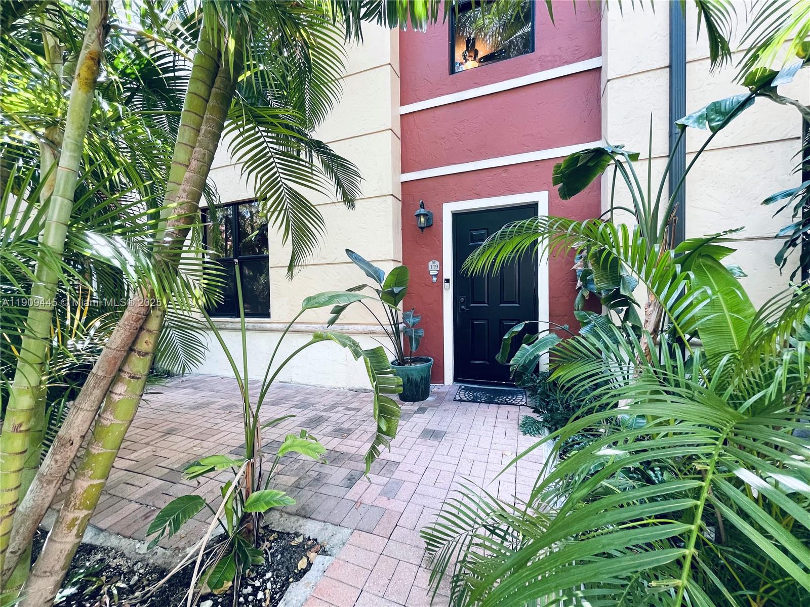 888 Douglas Road, Unit 119 Coral Gables, FL 33134 - Photo 14 of 36 a front view of a house with a garden