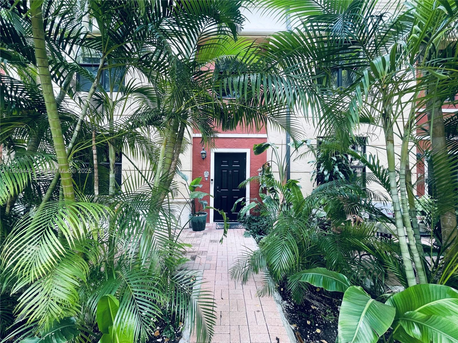 888 Douglas Road, Unit 119 Coral Gables, FL 33134 - Photo 15 of 36 a front view of a house with a plant