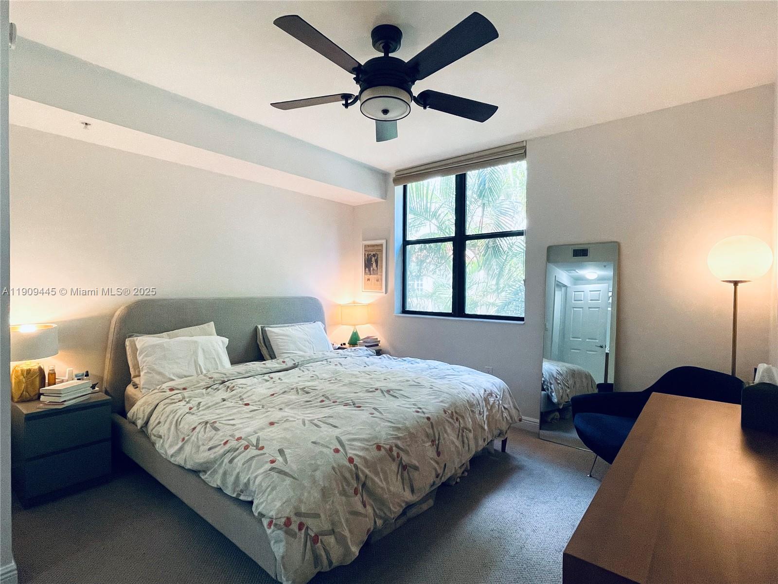 888 Douglas Road, Unit 119 Coral Gables, FL 33134 - Photo 16 of 36 a bedroom with bed and window