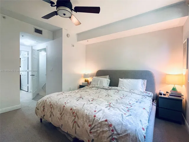 a bedroom with a bed and lamp