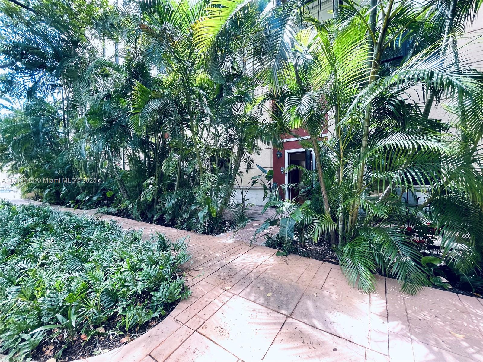 888 Douglas Road, Unit 119 Coral Gables, FL 33134 - Photo 26 of 36 a front view of a house with a yard