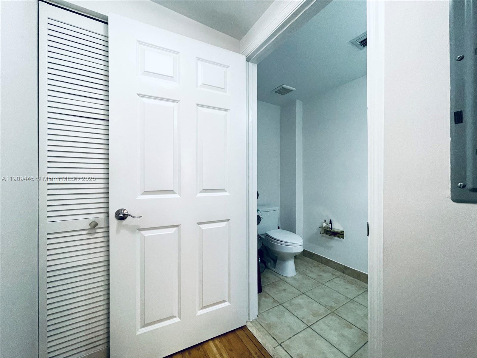 888 Douglas Road, Unit 119 Coral Gables, FL 33134 - Photo 28 of 36 a bathroom with a toilet