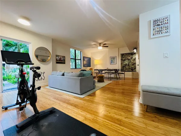 a living room with furniture and a wooden floor