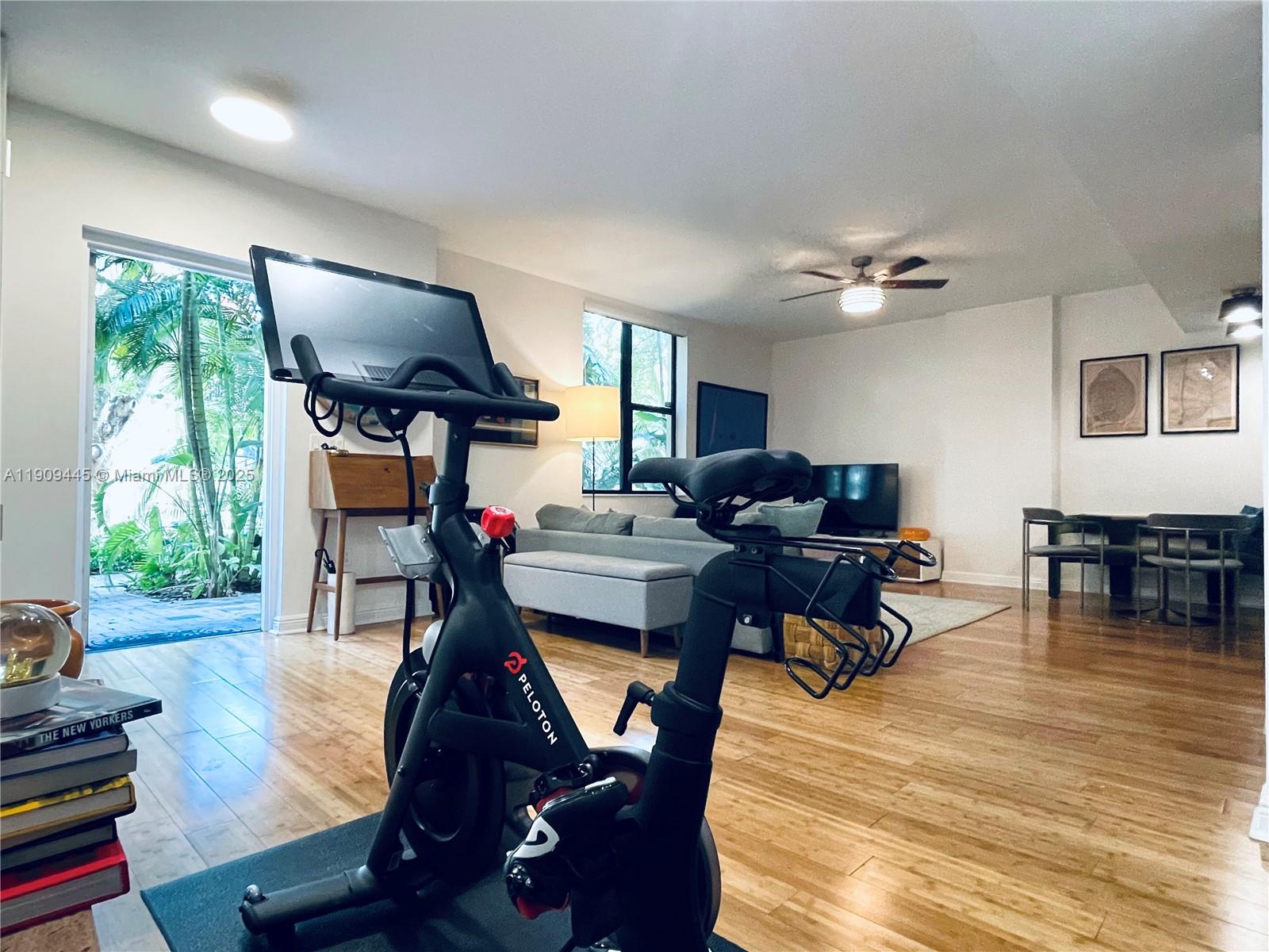 888 Douglas Road, Unit 119 Coral Gables, FL 33134 - Photo 4 of 36 a living room with furniture and a wooden floor