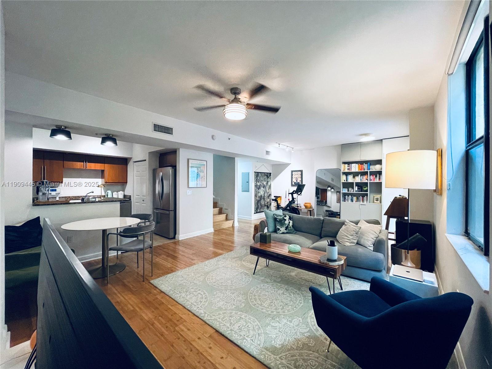888 Douglas Road, Unit 119 Coral Gables, FL 33134 - Photo 5 of 36 a living room with furniture and a flat screen tv