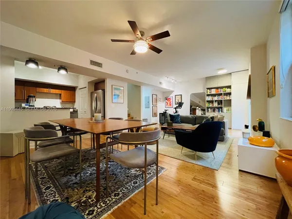 a kitchen with stainless steel appliances granite countertop a refrigerator sink and stove