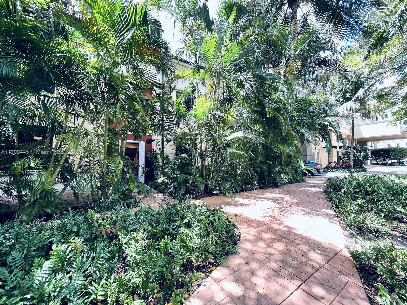 888 Douglas Road, Unit 119 Coral Gables, FL 33134 - Photo 10 of 36 a pathway of a house with a yard